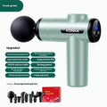 Konka V19 grey mini massage gun with set of 8 different coloured silicone and foam massage heads on a table.