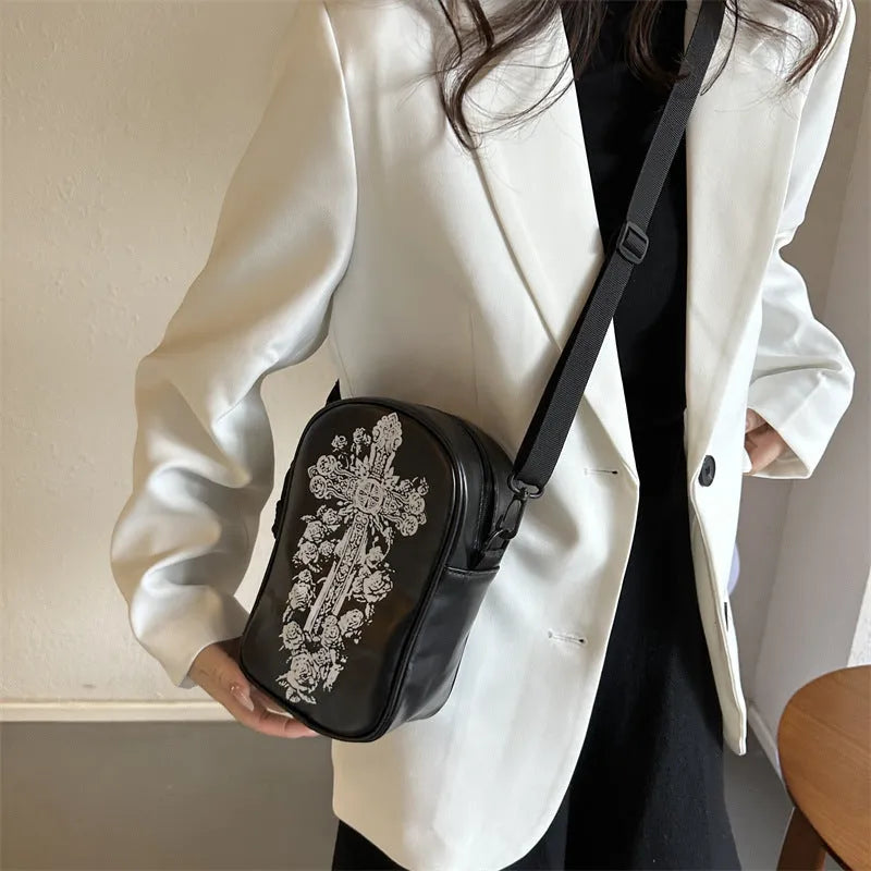 Black mini square crossbody bag with orange cartoon pumpkin, white ghost, and black bat graffiti print.