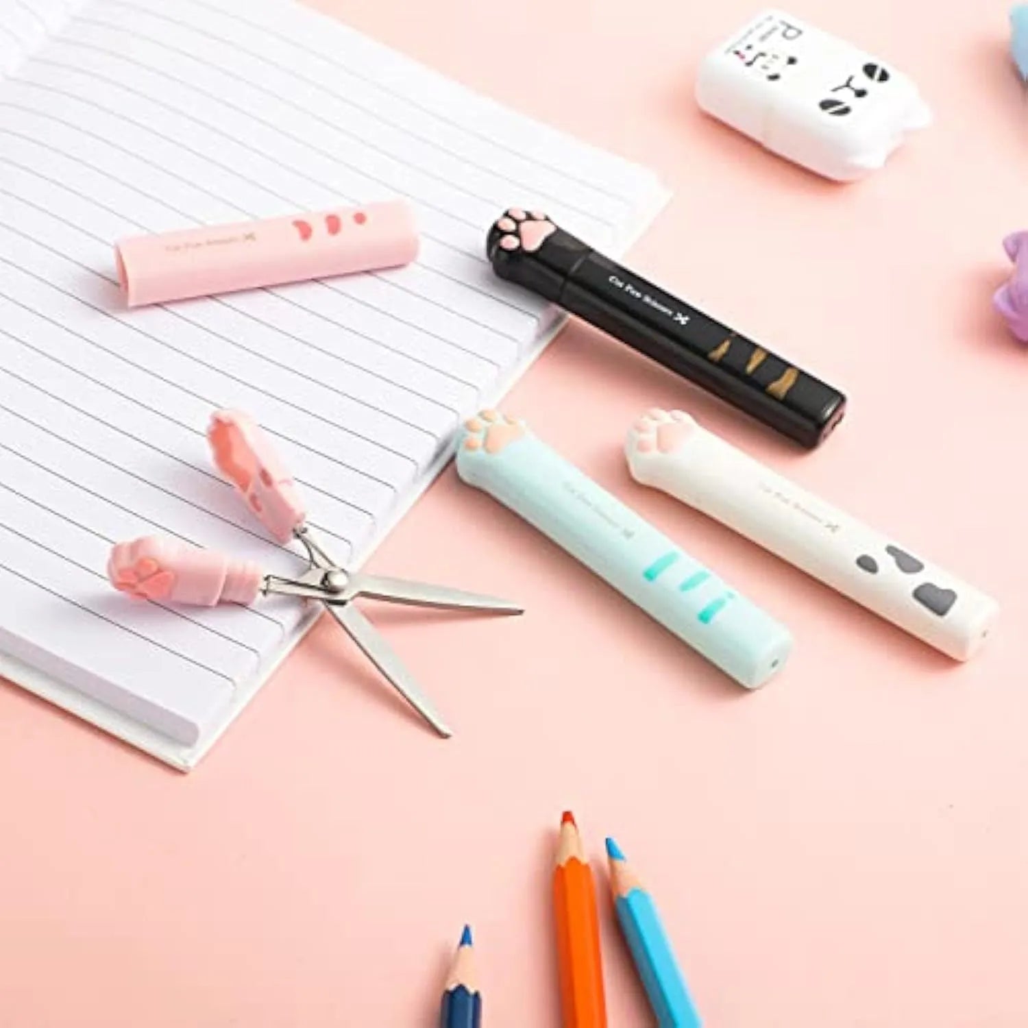 Small folding scissors with cat paw handles in pink, white, black, and blue colour options.