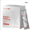 Two single-serve sachets of anti-ageing drink powder with nicotinamide riboside and PQQ on a wooden surface