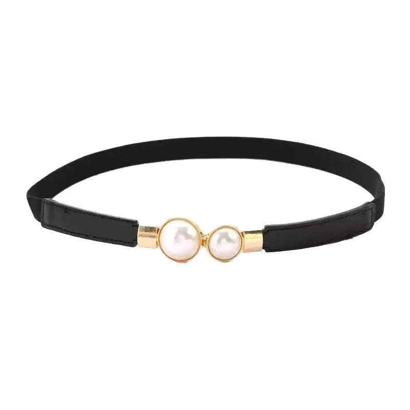 Thin black PU leather women's belt with an alloy buckle on a pair of jeans