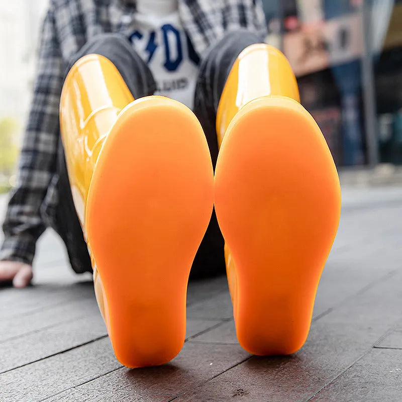 Flat plastic rain boots in white and yellow colours with high tube design