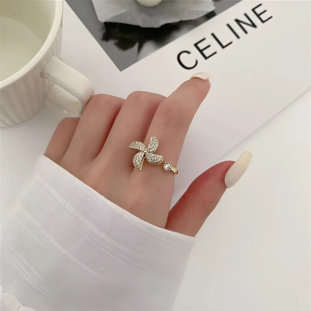Gold and silver rotating windmill rings showing the spinning geometric copper design.
