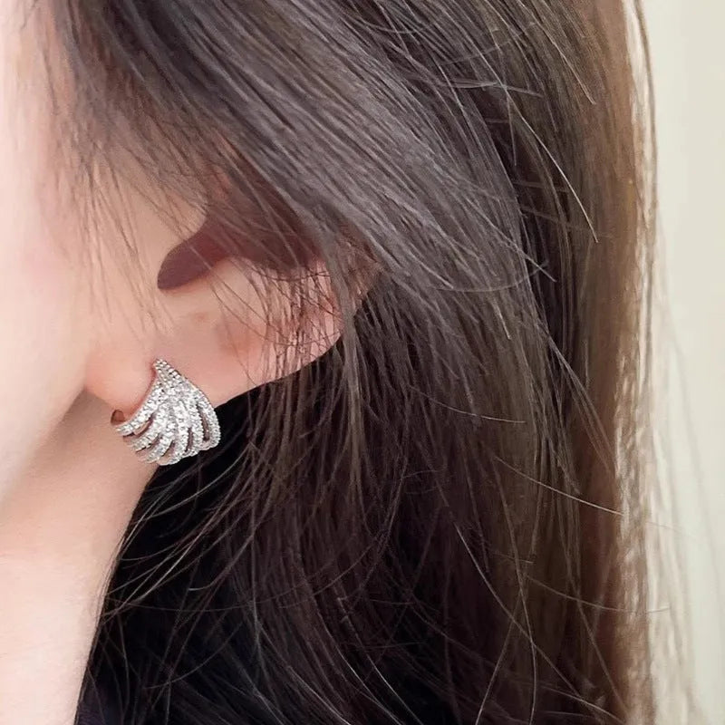 A pair of geometric zircon earrings with a line design and platinum electroplated finish.