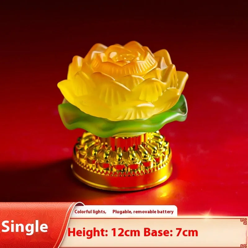 A yellow Chinese-style lotus Buddha lamp made of ABS plastic on a wooden surface.