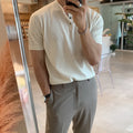 Man wearing a thin black short-sleeved knitted slim-fit pullover shirt.