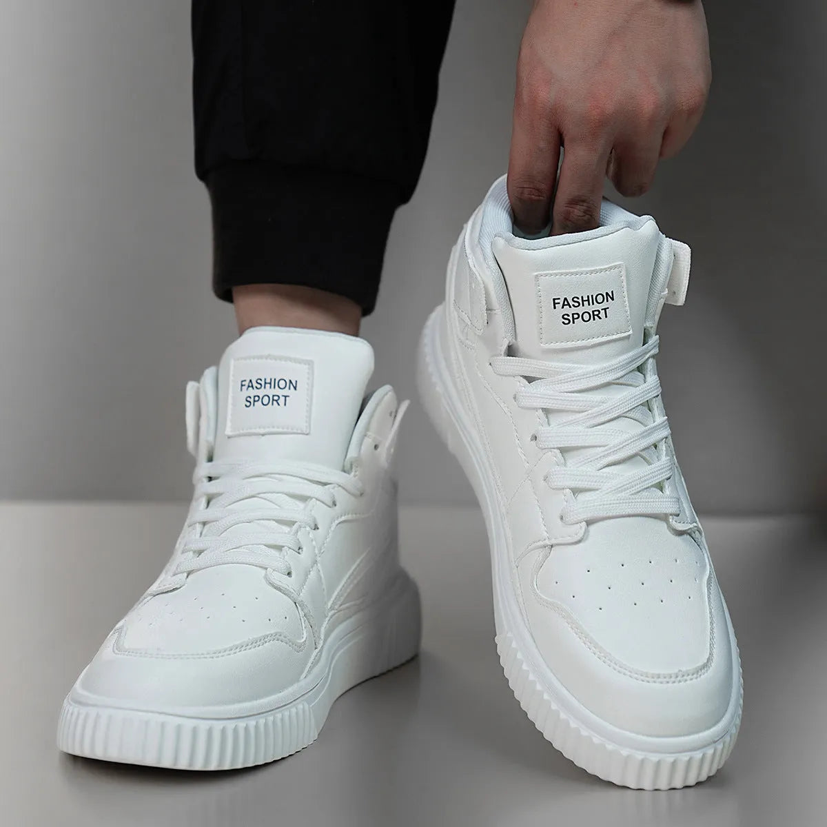 Men's white casual shoes with round toe and microfiber upper on a plain background.