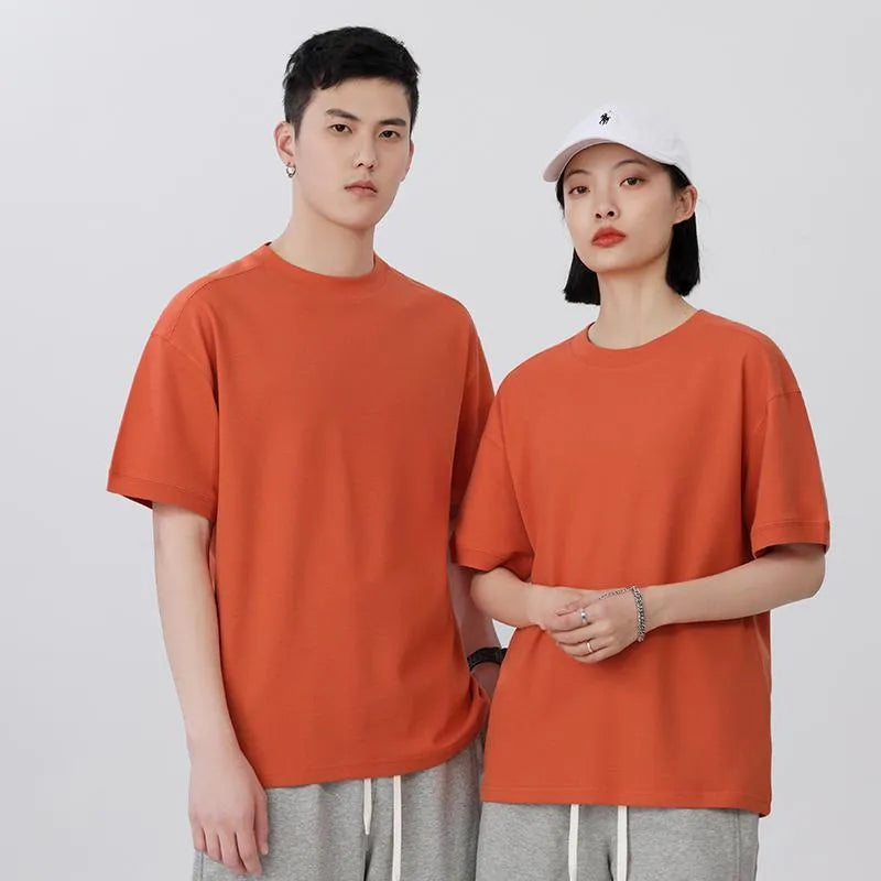 Men's loose-fit short-sleeved cotton pique T-shirt on a hanger, shown in a solid colour.