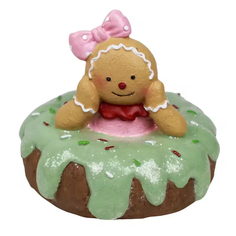 Hand drawn cartoon resin gingerbread man Christmas ornament with pink donut motif on white background