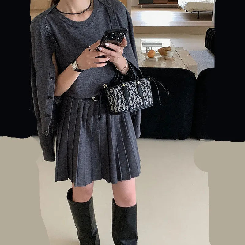 Women's grey art retro knitted two-piece set with pleated vest skirt, belt, and long sleeve cardigan featuring a 3D pattern.