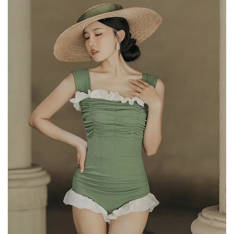 Black high-waisted one-piece swimsuit with triangle design on mannequin
