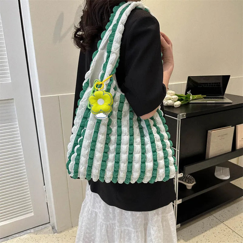Women's soft pleated bubble shoulder bag in a vertical square shape with a pendant, shown in one of five colour options.