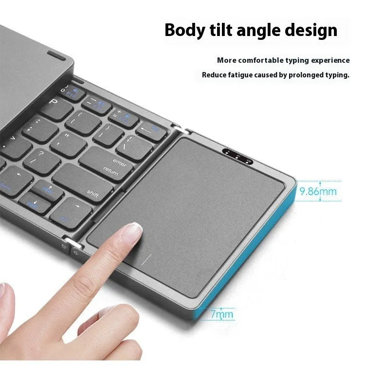 Three folding wireless Bluetooth keyboard with touch pad in black, unfolded on a desk