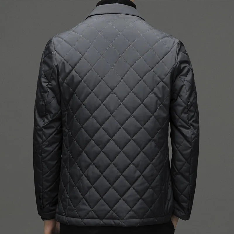 Man wearing a thick black lapel down jacket with side seam pockets.