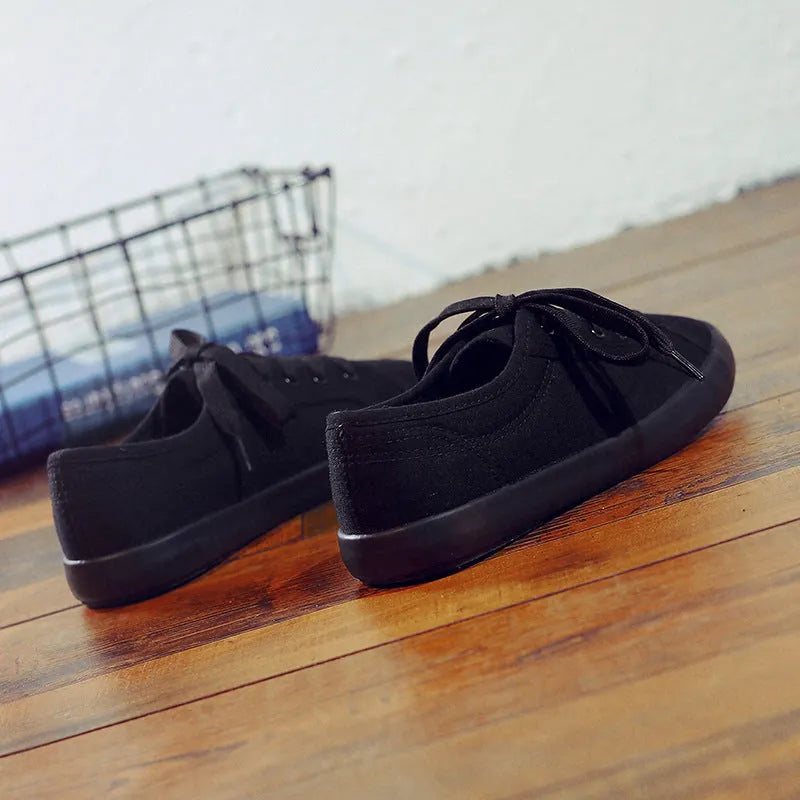 All-black women's canvas lace-up work shoes with flat rubber soles