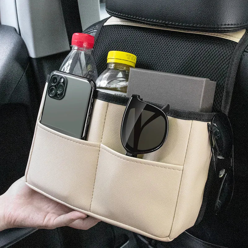 Leather car rear seat storage bag with plug-in installation, 25x16x8cm, in black on a car seat back
