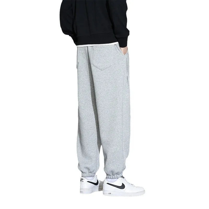 Men's loose grey sports trousers with drawstring waist in cotton-polyester blend