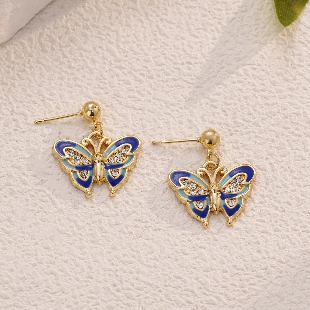 Dripping oil butterfly stud earrings in zinc alloy, classic style, colour O-4-17, on display