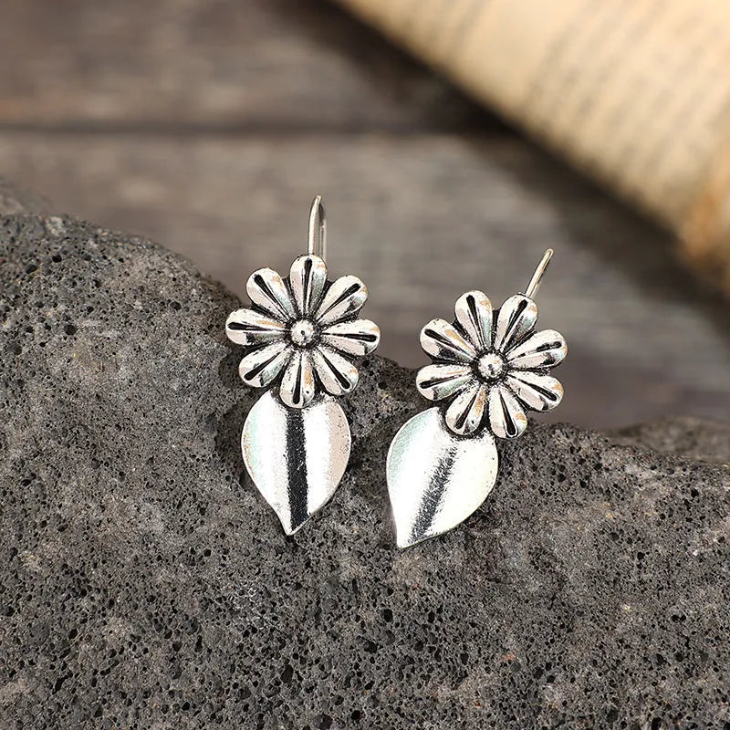 Silver alloy clip-on earrings with artificial gemstone inlays, vintage floral style, sold as a pair