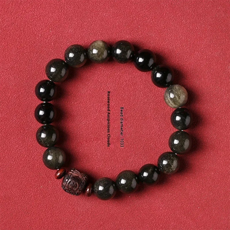 Close-up of a hand-woven Better Luck Beads bracelet with 10mm round Golden Obsidian beads in a retro style.