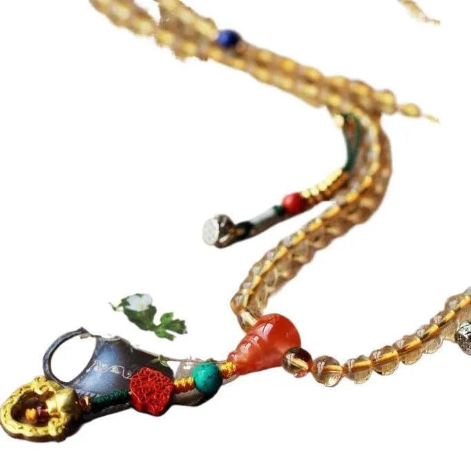 Close-up of a yellow natural citrine bracelet with 1mm beads on a filament string.