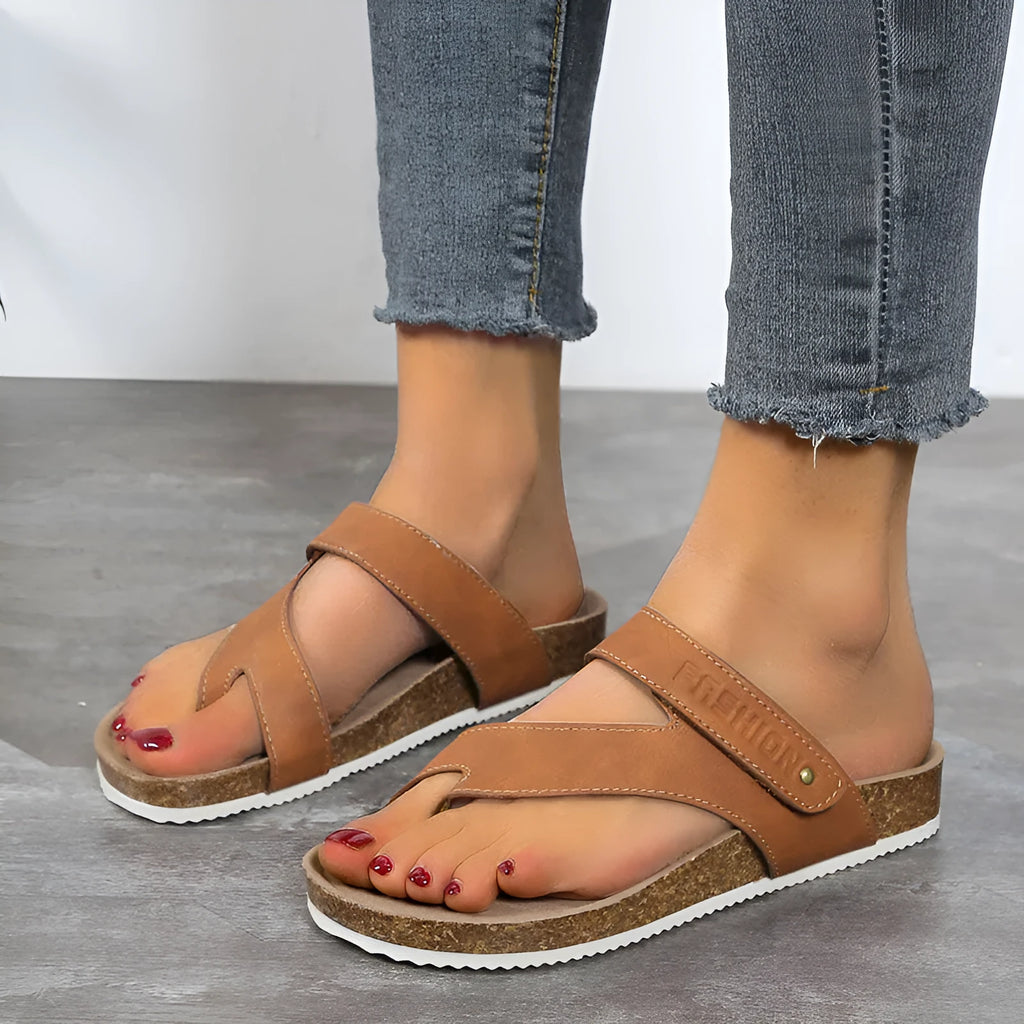 Flat thong sandals with a toe ring and thick foam sole in a solid colour.