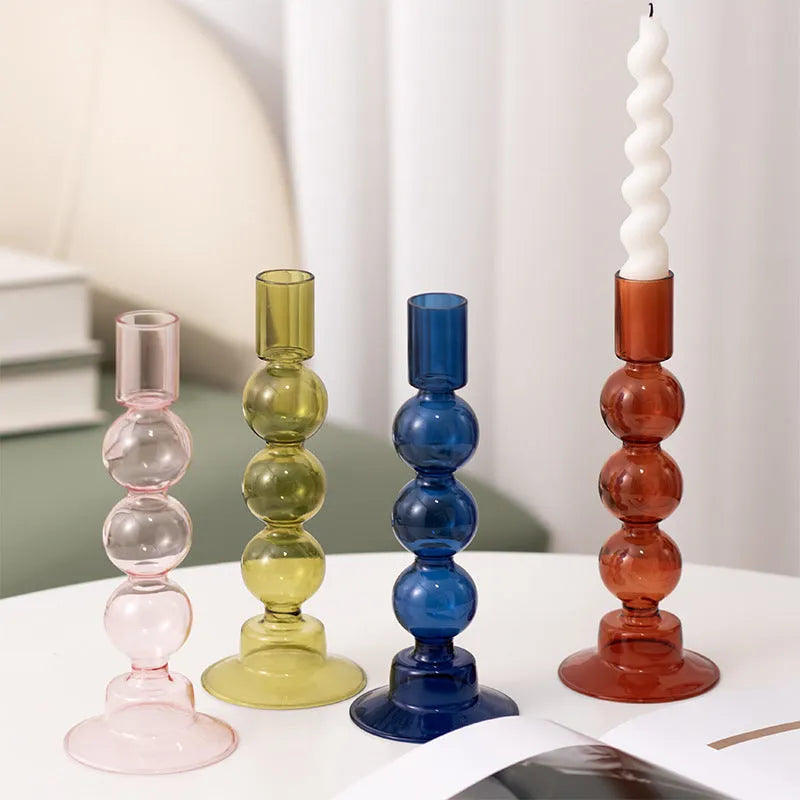 Transparent borosilicate glass candle holder in Three Ball Mott design, available in brown, blue, pink, green