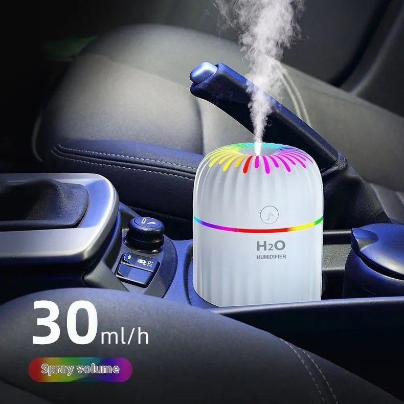 Mini green car-shaped USB aromatherapy humidifier on a desk