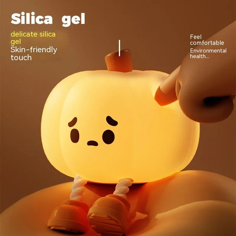 Orange silicone pumpkin-shaped night light with USB charging cable