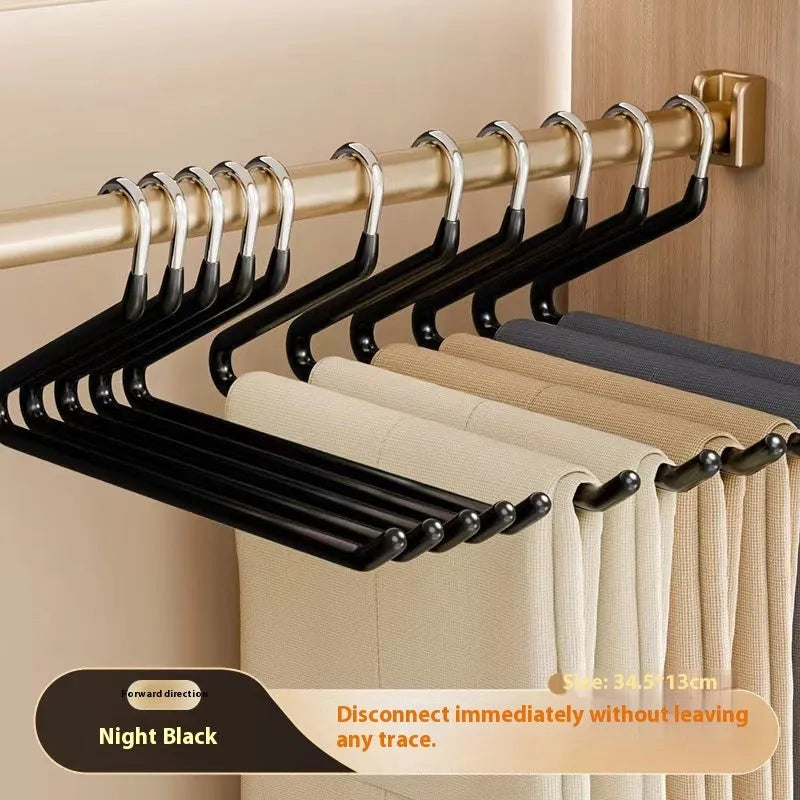 Non-slip Z-shaped trouser hanger in stainless steel dipped finish, shown in cream white, green and black