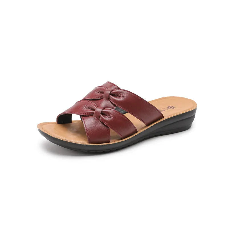 Beige women's cowhide mom sandal slippers with straps and a soft sole on a white background.