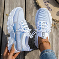 Women's Flyknit mesh lace-up sneakers in a grey colourway with a round toe and flat rubber sole.