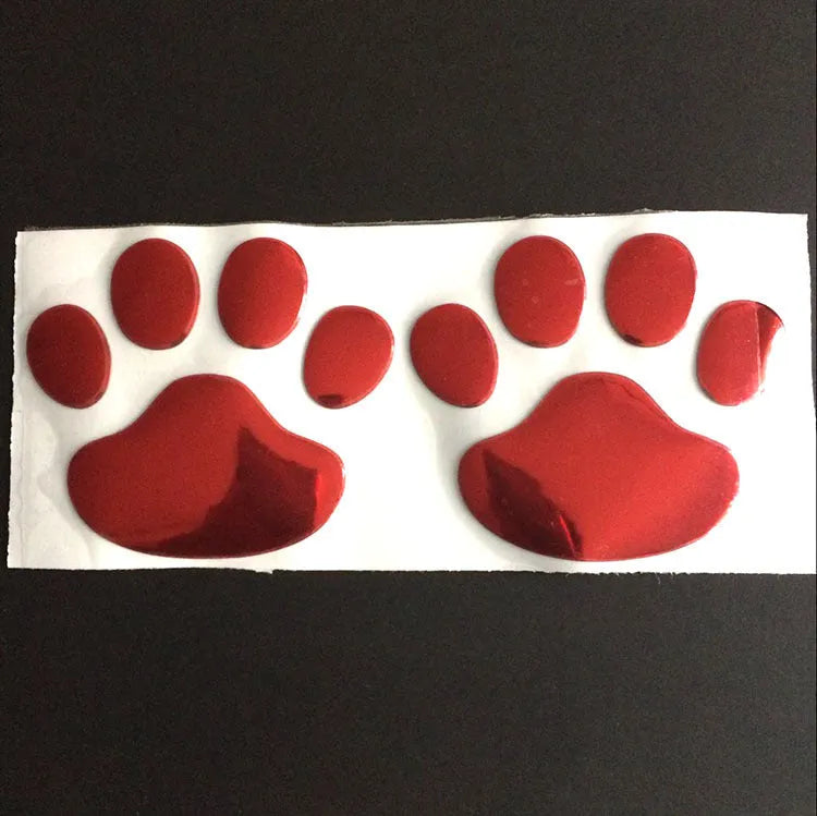 PVC car sticker shaped like a hand holding a brush, decorated with dog footprints pattern.