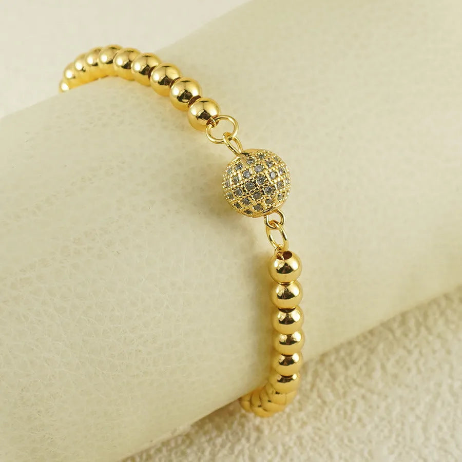 Close-up of a women's copper heart bracelet with a round zircon stone in an Arabic style.