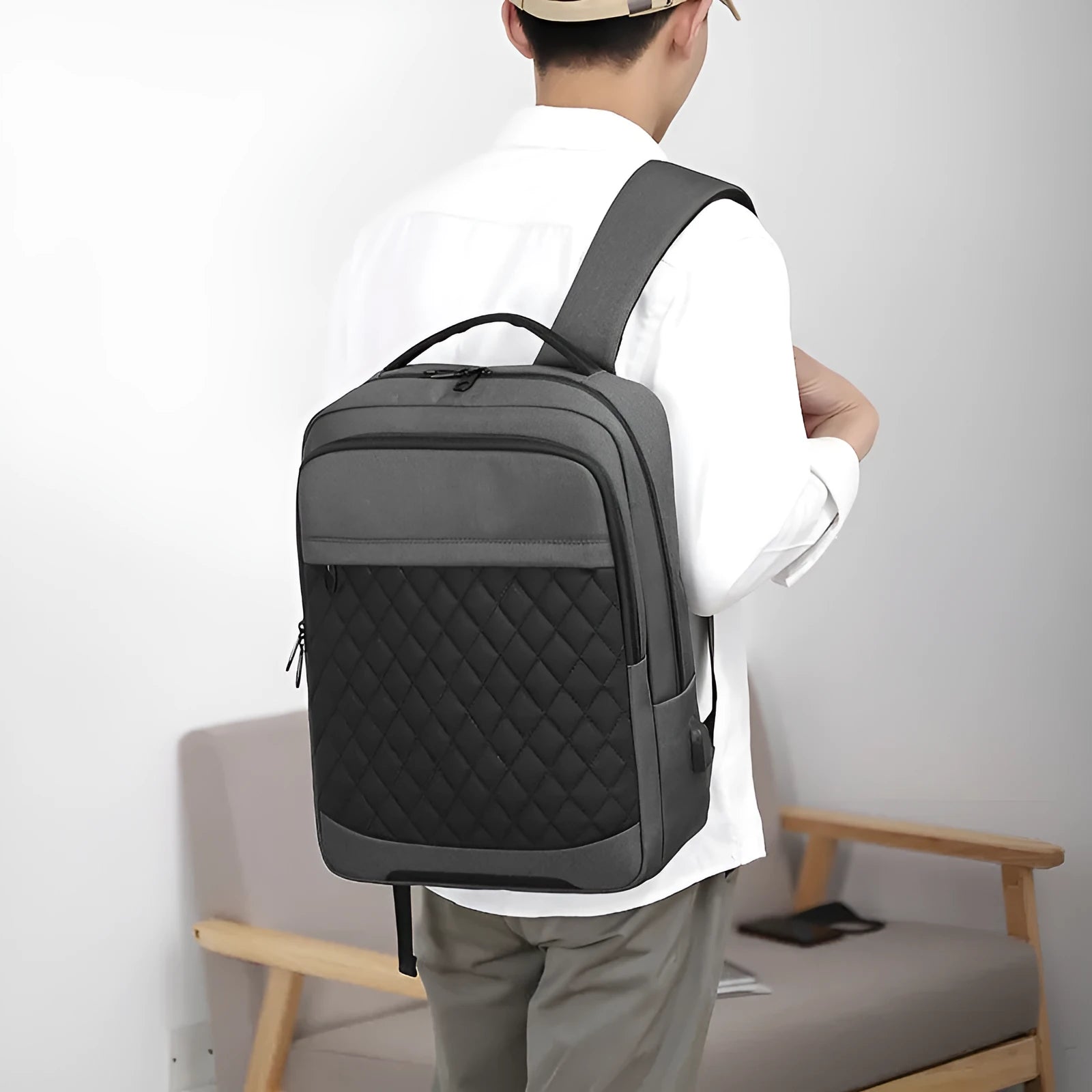 Men's Oxford cloth backpack in black with curved shoulder straps and diamond mesh detailing