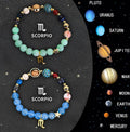 Two natural stone beaded bracelets with adjustable cords on a table, showing different zodiac sign designs.