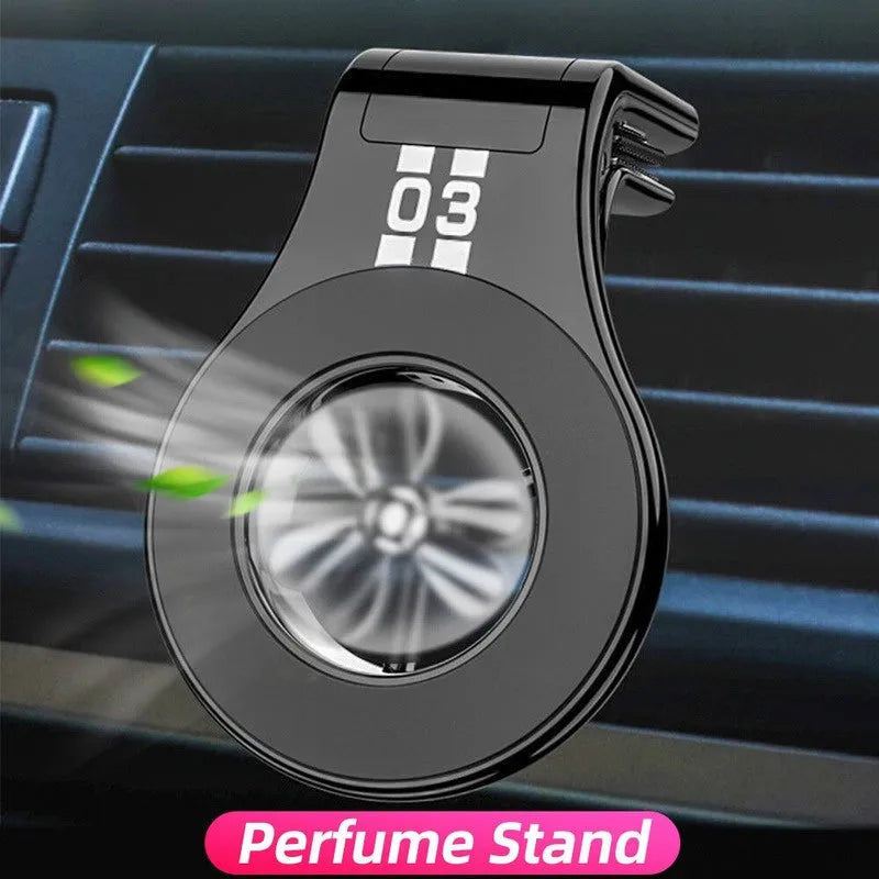 Black magnetic phone holder clipped onto a car air vent, showing phone attached and 360-degree rotation.