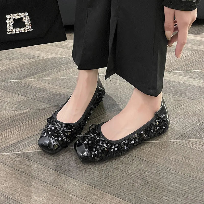 Women's black satin Mary Jane pump with height increasing insole, rhinestones, buckle, and square toe