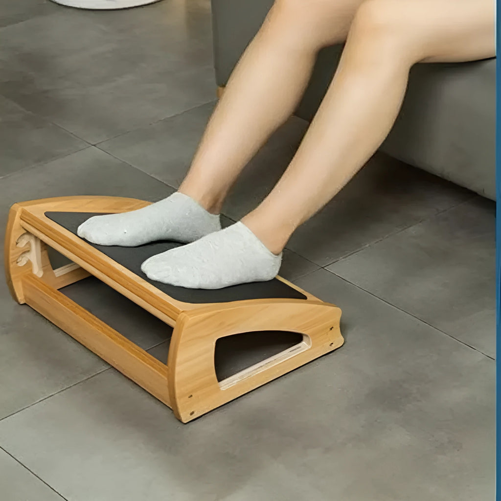 Wooden adjustable height office desk footstool in a natural wood colour.
