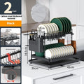 White double-layer carbon steel kitchen draining and storage rack holding plates and utensils.