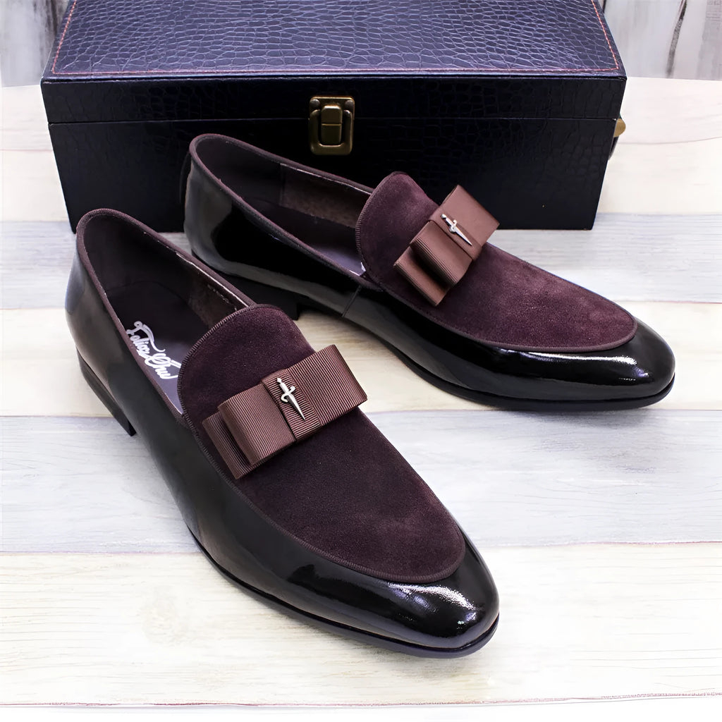 Men's glossy black patent leather low-top shoes with a tassel detail on a white background