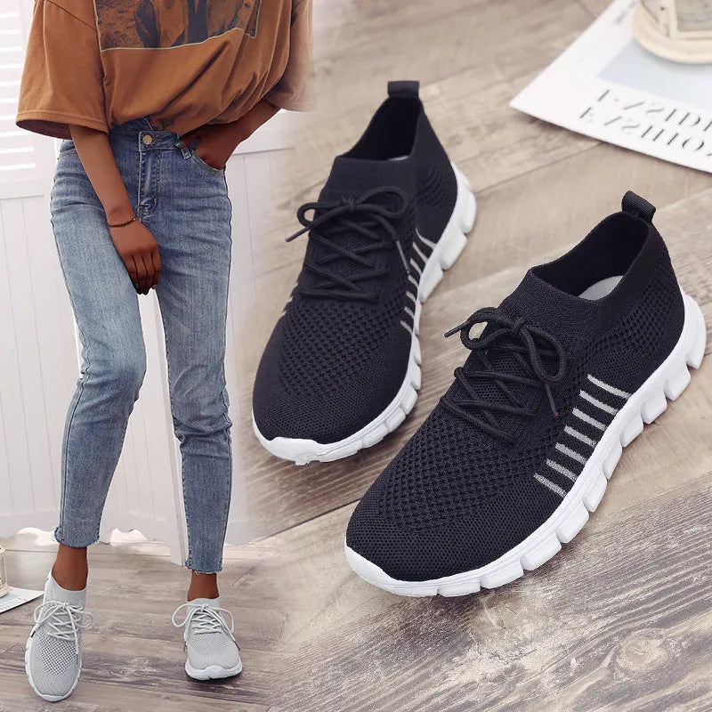Beige ladies flying knit flat shoes with mesh upper, round toe, and low heel on a plain background