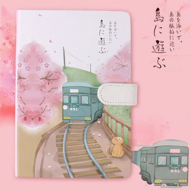 A5 wire-bound retro notebook open showing full-colour vintage illustrations, with a pen.