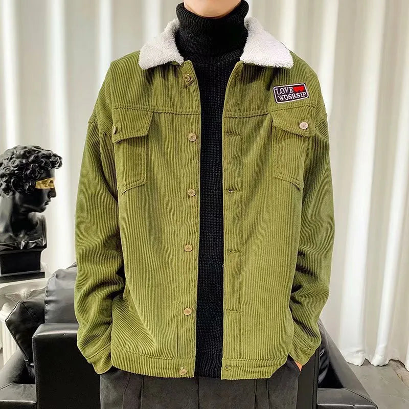 A man's loose-fit corduroy jacket in khaki colour with stick pockets, shown on a hanger.