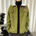 A man's loose-fit corduroy jacket in khaki colour with stick pockets, shown on a hanger.