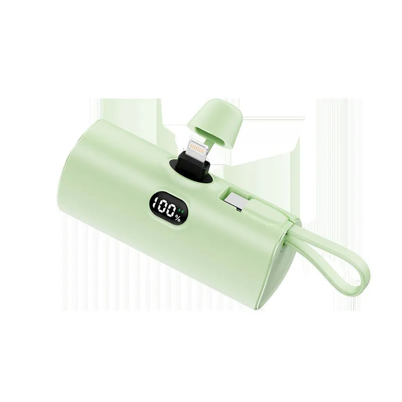 Capsule-shaped digital display power bank in multiple colours showing its size and built-in plug.