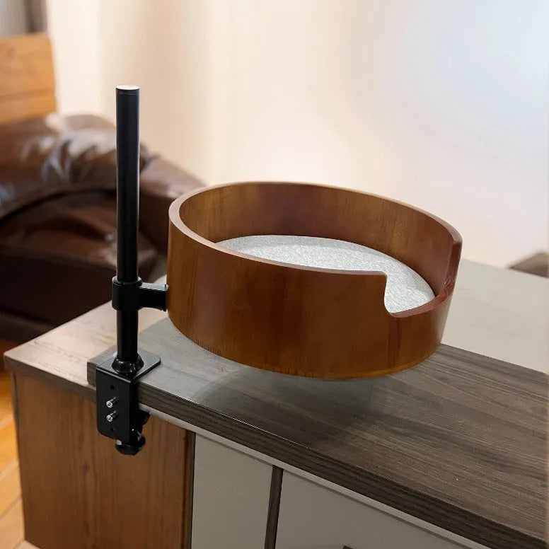 Round desktop suspended cat nest with stainless steel frame in light gray, placed on a wooden desk
