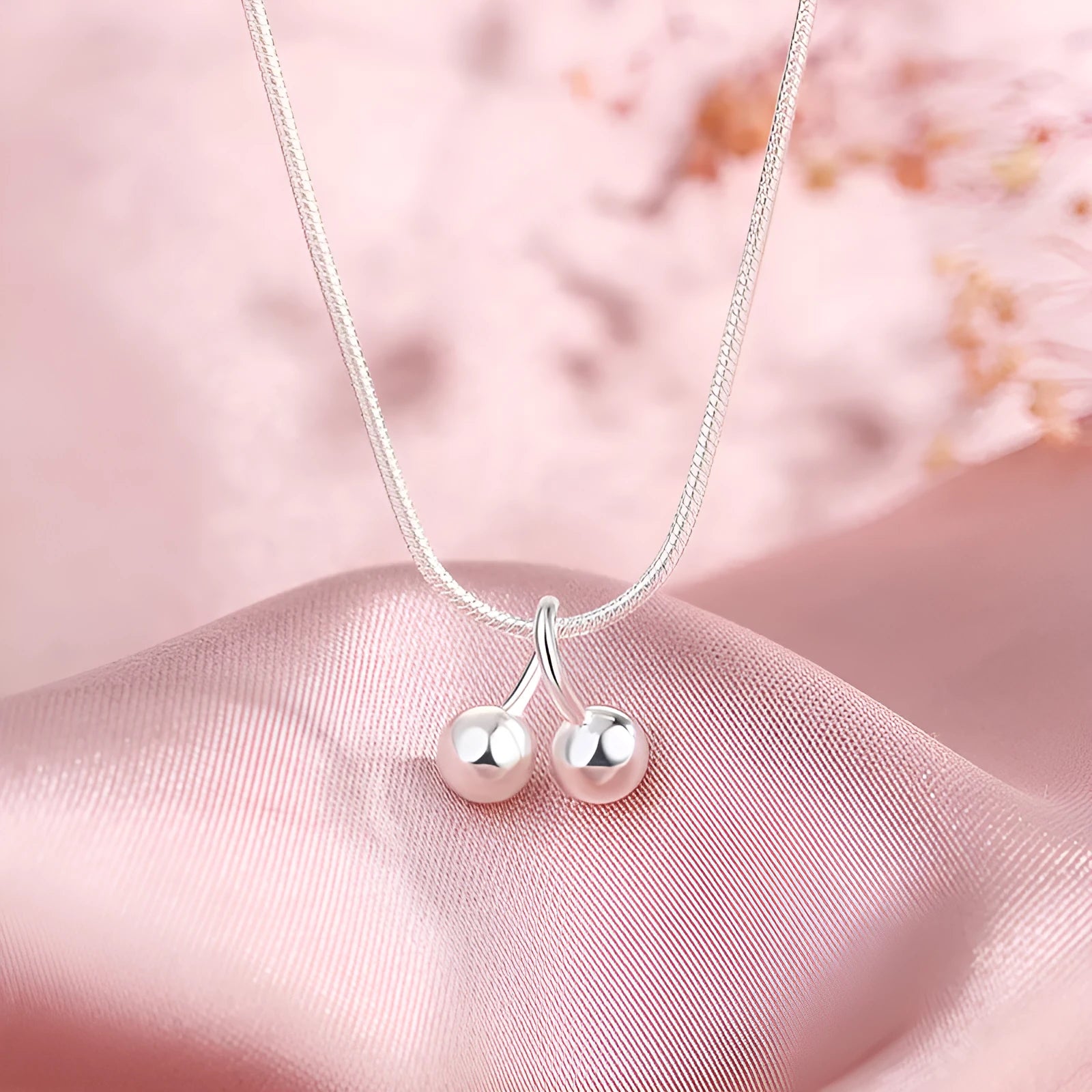 S925 silver cherry pendant necklace with adjustable snake bones chain on a white background.