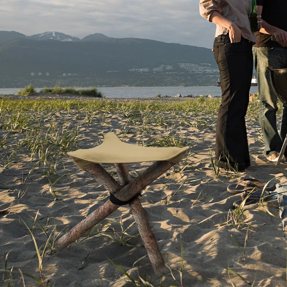 Folding portable camping stool with triangular fabric seat in black