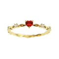Copper fashion ring with peach heart zircon detail in gold or silver electroplating, shown on a finger.